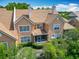 Back exterior view of a home with tile roof, screened in patio and lush landscaping at 7323 Cypress Grove Rd # 87, Orlando, FL 32819
