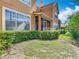 View of the backyard and exterior of a house with a screened porch and lush landscaping at 7323 Cypress Grove Rd # 87, Orlando, FL 32819