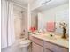 Cozy bathroom featuring a shower-tub combo and vanity with decorative accents at 7323 Cypress Grove Rd # 87, Orlando, FL 32819