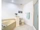 Bathroom with a soaking tub, shower, toilet and modern fixtures create a clean, comfortable space at 7323 Cypress Grove Rd # 87, Orlando, FL 32819