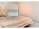Calm bedroom featuring a double bed, bedside lamp, and large window providing natural light at 7323 Cypress Grove Rd # 87, Orlando, FL 32819