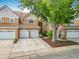 Exterior of home featuring a tile roof, neutral paint and three garages at 7323 Cypress Grove Rd # 87, Orlando, FL 32819