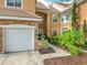 Charming home exterior with stone accents, well-maintained landscaping, and inviting walkway at 7323 Cypress Grove Rd # 87, Orlando, FL 32819