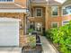 Charming home exterior with stone accents, well-maintained landscaping, and inviting walkway at 7323 Cypress Grove Rd # 87, Orlando, FL 32819