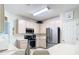 Bright kitchen with white cabinetry and stainless steel refrigerator at 7323 Cypress Grove Rd # 87, Orlando, FL 32819