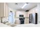 Well-lit kitchen featuring white cabinets and stainless steel appliances at 7323 Cypress Grove Rd # 87, Orlando, FL 32819