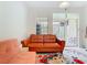 Comfortable living room with a bright, floral rug and sliding glass doors to an outdoor seating area at 7323 Cypress Grove Rd # 87, Orlando, FL 32819