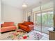 Comfortable living room with a bright, floral rug and sliding glass doors to an outdoor seating area at 7323 Cypress Grove Rd # 87, Orlando, FL 32819