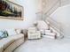 Bright living room with a decorative painting, comfortable seating, and a staircase at 7323 Cypress Grove Rd # 87, Orlando, FL 32819