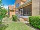 View of the backyard and exterior featuring a screened porch and garden at 7323 Cypress Grove Rd # 87, Orlando, FL 32819