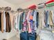 Organized walk-in closet featuring ample storage space for clothing, luggage, and accessories at 7323 Cypress Grove Rd # 87, Orlando, FL 32819