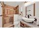 Modern bathroom with wooden shower tiles, granite countertops, and unique vessel sink at 8248 Limetree Ct, Orlando, FL 32836