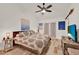 Relaxing bedroom featuring wood-look flooring, ceiling fan, and sliding glass door access to exterior at 8248 Limetree Ct, Orlando, FL 32836