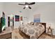 Comfortable bedroom featuring wood-look flooring, a ceiling fan, and access to walk-in closet at 8248 Limetree Ct, Orlando, FL 32836