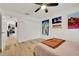 Bedroom with wood-look flooring, closet, and access to other rooms of the house at 8248 Limetree Ct, Orlando, FL 32836