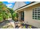 Inviting front entrance with garden features and a charming wind chime at 8248 Limetree Ct, Orlando, FL 32836