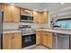 Well-lit kitchen featuring stainless steel appliances and bright cabinets, offering modern convenience at 8248 Limetree Ct, Orlando, FL 32836