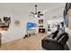 Open floor plan living room with brick fireplace and hardwood-style floors at 8248 Limetree Ct, Orlando, FL 32836
