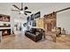 Open living room features fireplace and unique barn door to bedroom at 8248 Limetree Ct, Orlando, FL 32836