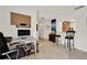 A well-lit home office space with neutral tile floors and access to the kitchen at 8248 Limetree Ct, Orlando, FL 32836