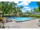 Inviting community pool surrounded by lush landscaping and comfortable lounge chairs at 8248 Limetree Ct, Orlando, FL 32836