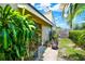 Side yard featuring mature landscaping, a privacy fence, and access to the home at 8248 Limetree Ct, Orlando, FL 32836