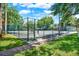 Fenced tennis court offering recreational opportunities for residents at 8248 Limetree Ct, Orlando, FL 32836