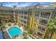 Community with pool, manicured landscaping, and vibrant exterior colors at 860 N Orange Ave # 448, Orlando, FL 32801