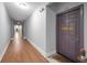 Hallway with a wooden floor and a view of the purple apartment door at 860 N Orange Ave # 448, Orlando, FL 32801