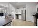 Kitchen with stainless steel appliances, white cabinets, bar seating and tile floors at 860 N Orange Ave # 448, Orlando, FL 32801