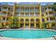 Beautiful yellow building with a refreshing pool area and ample seating at 860 N Orange Ave # 448, Orlando, FL 32801