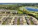 An aerial view of a community with a lake nearby in the background at 9356 St Therese St, Groveland, FL 34736