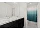 Well-lit bathroom with double sinks, spacious vanity, and a stylish shower curtain at 9356 St Therese St, Groveland, FL 34736