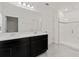 Bright bathroom featuring double sinks, a modern shower, and contemporary fixtures at 9356 St Therese St, Groveland, FL 34736