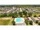 Aerial view of community pool surrounded by green space and parking at 9356 St Therese St, Groveland, FL 34736