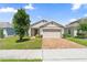 Charming single-Gathering home with a paved driveway and well-manicured lawn at 9356 St Therese St, Groveland, FL 34736