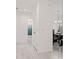 Bright hallway leads to the bathroom and dining area, showcasing the home's open layout and tile floors at 9356 St Therese St, Groveland, FL 34736