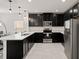 Modern kitchen with black cabinets, quartz countertops, stainless steel appliances, and stylish pendant lighting at 9356 St Therese St, Groveland, FL 34736