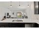 Open concept kitchen with island, stainless steel appliances, and view into the living area at 9356 St Therese St, Groveland, FL 34736