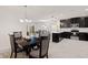 Open living space with dining area and kitchen, featuring stylish decor and access to the backyard at 9356 St Therese St, Groveland, FL 34736