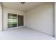 Covered patio with sliding glass doors and overhead light fixture at 9356 St Therese St, Groveland, FL 34736