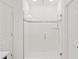 Elegant walk-in shower features glass enclosure and stylish tile accents, creating a modern bathroom at 9356 St Therese St, Groveland, FL 34736