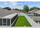 A fenced backyard with well-maintained lawn and screened patio, perfect for outdoor enjoyment at 9447 Brackin St, Orlando, FL 32825