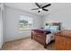 Comfortable bedroom featuring a ceiling fan, tile floor, and large window at 9447 Brackin St, Orlando, FL 32825