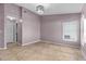 Well-lit bedroom featuring tile flooring, ample closet space, and a contemporary light fixture at 9447 Brackin St, Orlando, FL 32825