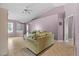 Bright living room with tile flooring, neutral walls, comfortable seating, and natural light at 9447 Brackin St, Orlando, FL 32825