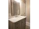 Bright bathroom features a modern vanity with marble countertop and a large mirror at 983 Bucksaw Pl, Longwood, FL 32750