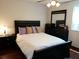 Comfortable bedroom features a dark wood bed frame, dresser, and ceiling fan at 983 Bucksaw Pl, Longwood, FL 32750