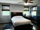 This bedroom has dark wood furniture, floors, and three windows with wooden blinds at 983 Bucksaw Pl, Longwood, FL 32750