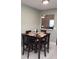 Cozy dining area with a dark wood table set for four, perfect for intimate meals and entertaining at 983 Bucksaw Pl, Longwood, FL 32750